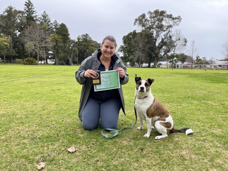 Happy woman with her dog after training session at Agile Dogs.