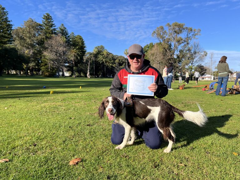 Woman with dog during Agile Dogs training session outdoors.