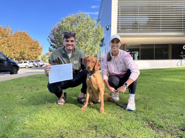 Happy dog owners with their certified dog after training at Agile Dogs.